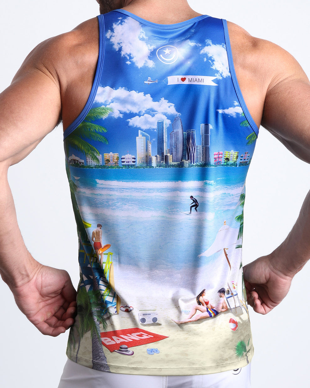 Back view of male model wearing the WISH YOU WERE HERE summer tank top for men by BANG! Miami featuring in white with a beach inspired art.
