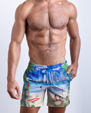 Frontal view of male model wearing the WISH YOU WERE HERE men's premium quality swimwear bottoms by the Bang! Clothes brand of men's swimwear from Miami.