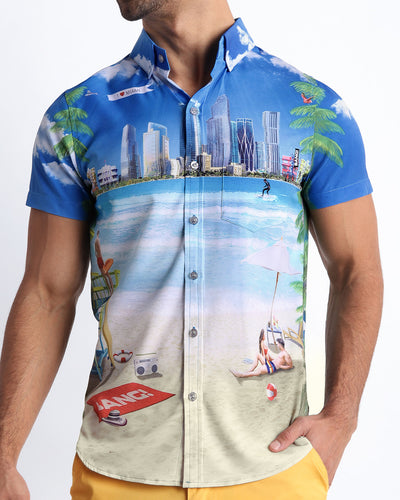 Front view of the WISH YOU WERE HERE men’s short-sleeve hawaiian stretch shirt featuring Miami Beach skyline art by the Bang! brand of men's beachwear from Miami.