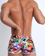 Back view of a sexy men's swimsuit featuring bold prints, dice, retro cars, bold colors and beautiful style