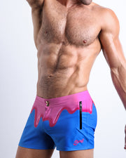 Left side view of men’s Summer swimsuit in YOU MELT ME featuring magenta pink melting ice cream print made by Miami based Bang brand of men's beachwear.