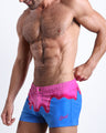 Frontal view of model wearing the YOU MELT ME men’s square leg swim trunks by the Bang! brand of men's beachwear from Miami.