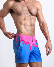 Side view of the men’s YOU MELT ME shorter leg length shorts featuring magenta pink melting ice cream print made by Miami based Bang! brand of men's beachwear